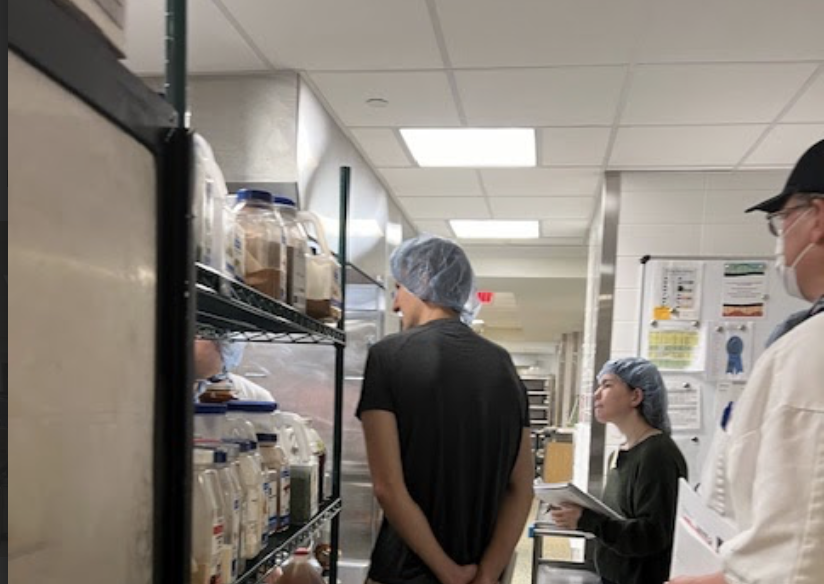 Three people in an industrial kitchen